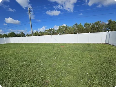 White vinyl PVC fence with decorative posts in Florida residential property