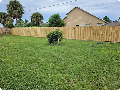 Custom wood privacy fence installation in Port St. Lucie backyard